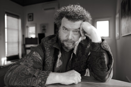 Danny McBride seated at a table in his home